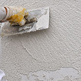 plastering a wall with lightweight insulating perlite plaster